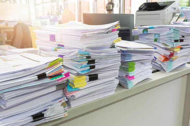 istock Pile of unfinished documents on office desk, Stack of business paper 687379384