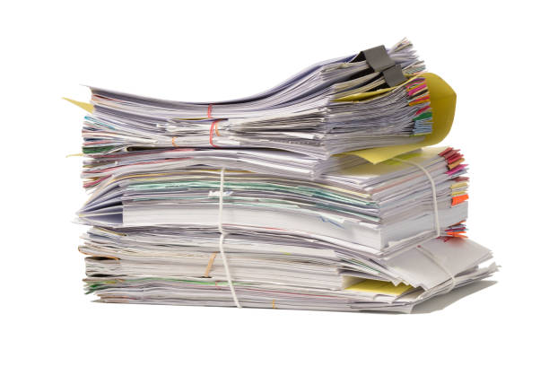 istock Stack of business papers isolated on white background 687379540