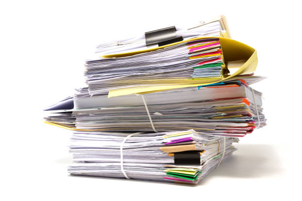 istock Stack of business papers isolated on white background 687379550