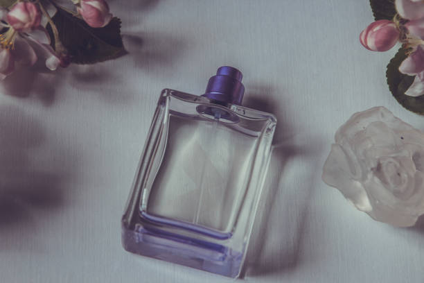 istock Women's perfume and spring apple blossom branch. Female romantic perfumes 687382318
