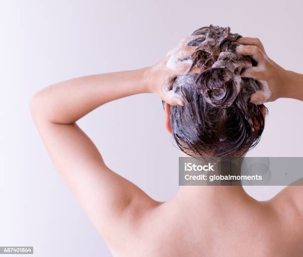Woman Shampoos Hair Close Up With Both Hands On A White Background Stock Photo - Download Image Now