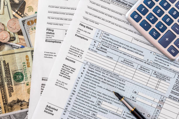 istock 2017 tax from 1040  with dollar and calculator 687406956