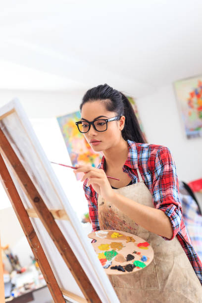 istock Young woman drawing in art studio 687407188