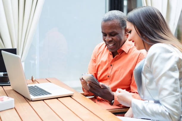 istock Happy african businessman using phone at cafe 687409804