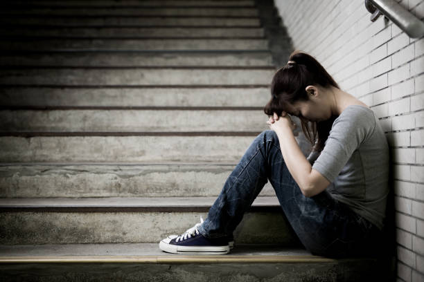 istock depressed woman in underground 687410218