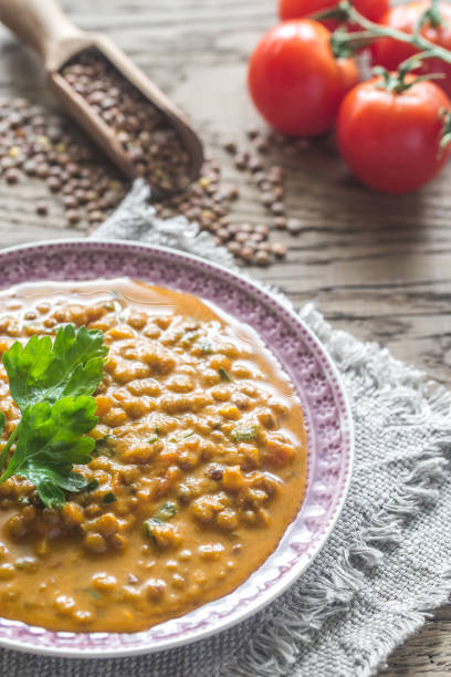 ciotola di curry di lenticchie: vista dall'alto - scoop in front of portion colors foto e immagini stock