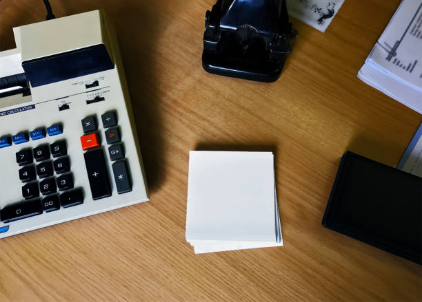 istock Retro calculator and paper punch on a desk. 687422318
