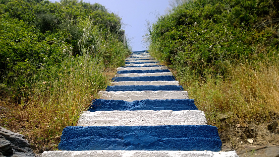 Original staircase in the colors of the flag of Greece is blue and white steps on the island of Crete in the village of Bali