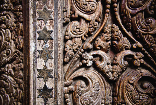 Beautiful wood carving on ancient door in Buddhist temple in Kandy, Sri Lanka. stock photo