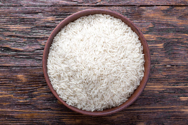 istock rice in a bowl on a wooden background 687438854