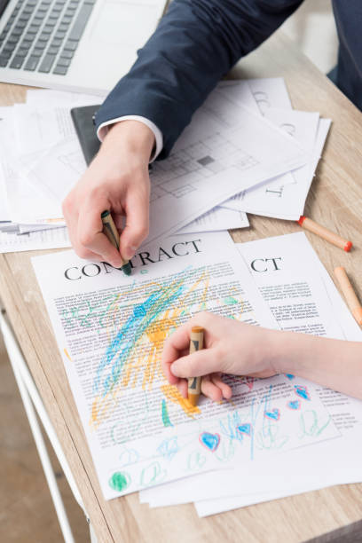 istock Businessman drawing on business papers with son at office 687441276
