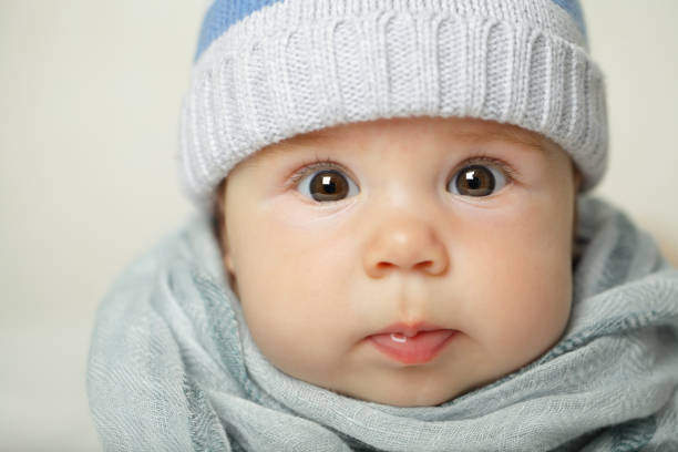 baby wearing a peci hat