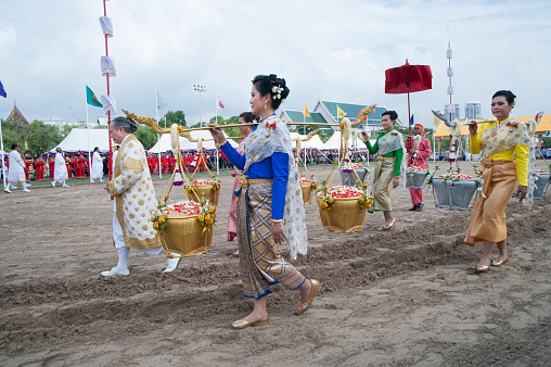 Bangkok,Thailand-May 13,2015 : Unidentified Queen of the Plowing Ceremony holding gold and silver basket in attend the ceremony -Perform for an auspicious beginning for planting season in the annual Ploughing Ceremony usually takes place in May every year at Sanam Luang near the Grand Palace in Bangkok. The ceremony has been performed since ancient times and designed to give an auspicious beginning to the new planting season on May 13,2015 in Bangkok , Thailand.
