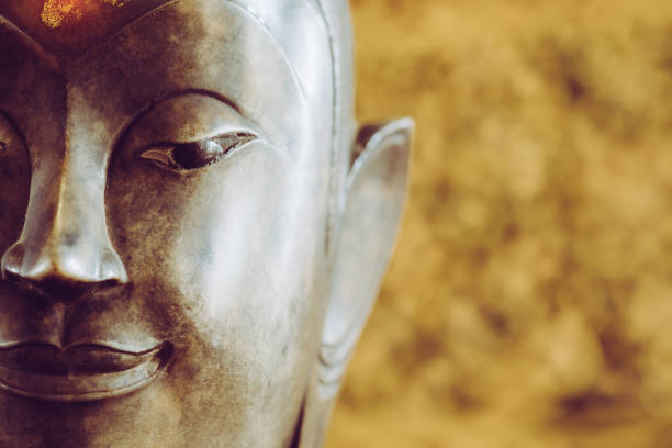 istock close up face on buddha head statue with Bokeh background 687441756