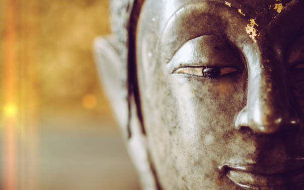 istock close up face on buddha head statue with Bokeh background 687442560