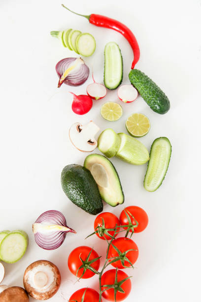 istock Fresh green and red vegetables lie on a white background, vegetarian food. 687445430
