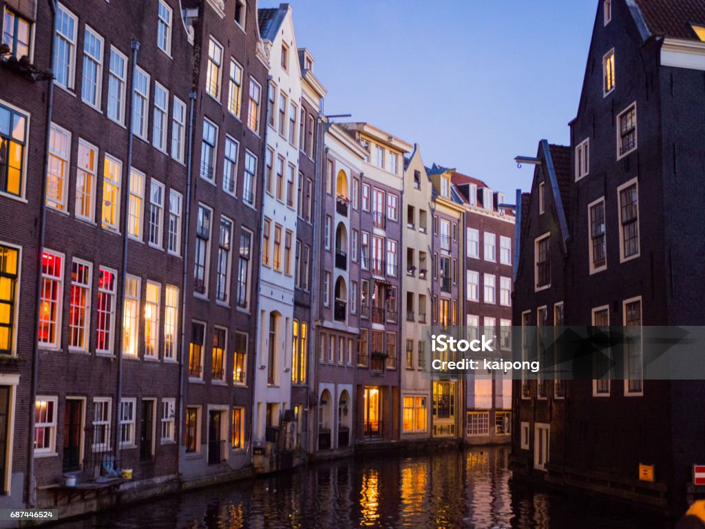 Blurred Europe city view, colorful buildings on canal at night Amsterdam Stock Photo