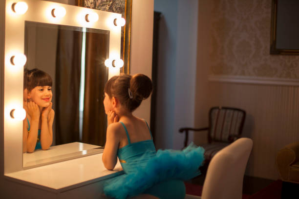 istock Cute little ballerina prepares for performance 687447440