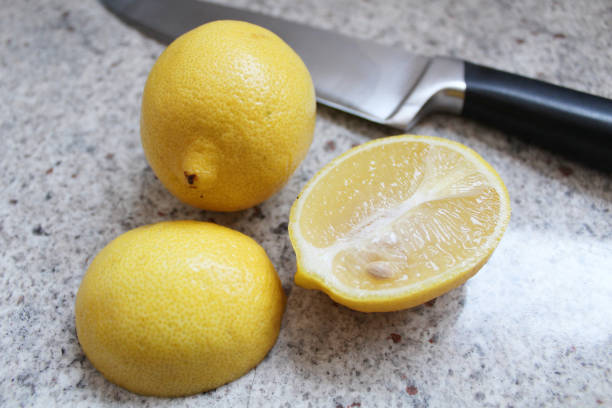 Fresh lemons on a granite background Ripe lemons on a stone granite benchtop kitchen background stone bench top view stock pictures, royalty-free photos & images