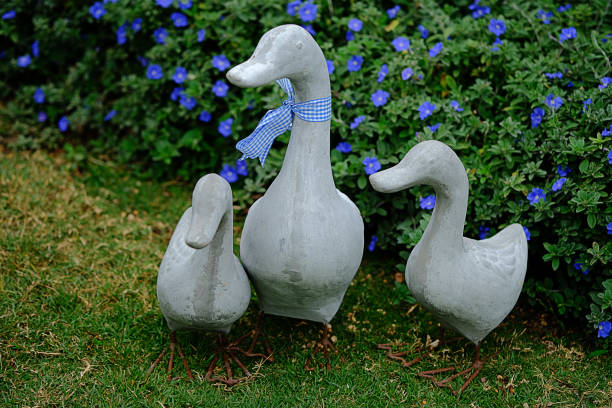 istock Duck family statue placed in a green park. 687449646