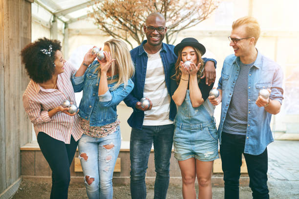 istock Young people in petanque game center 687449784