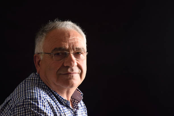 istock Portrait of a senior man with black background 687449848