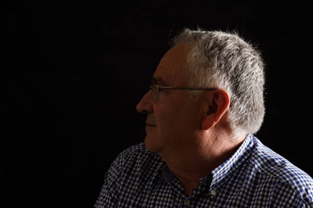 istock Portrait of a senior man with black background 687449850
