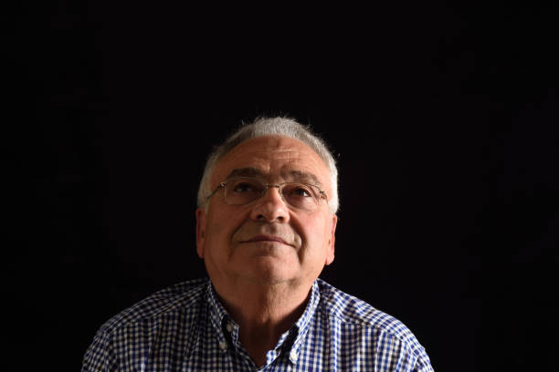 istock Portrait of a senior man with black background 687449942