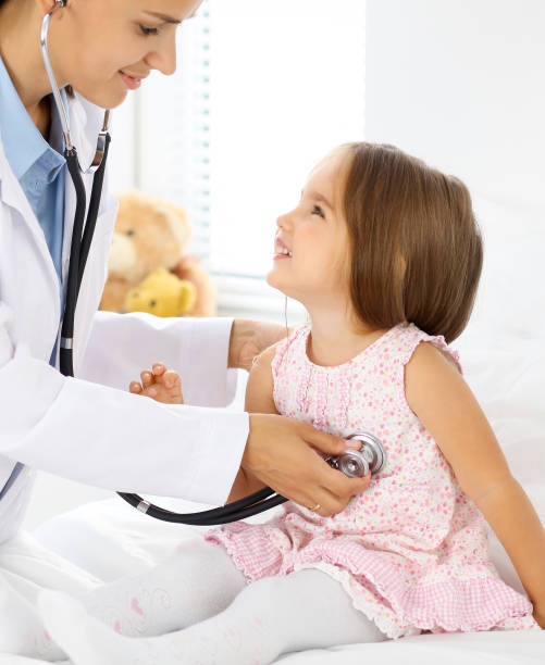 istock Doctor examining a little girl by stethoscope 687449944