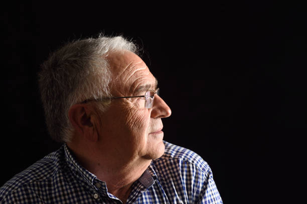 istock Portrait of a senior man with black background 687449946