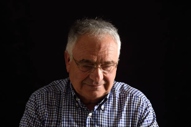 istock Portrait of a senior man with black background 687449964