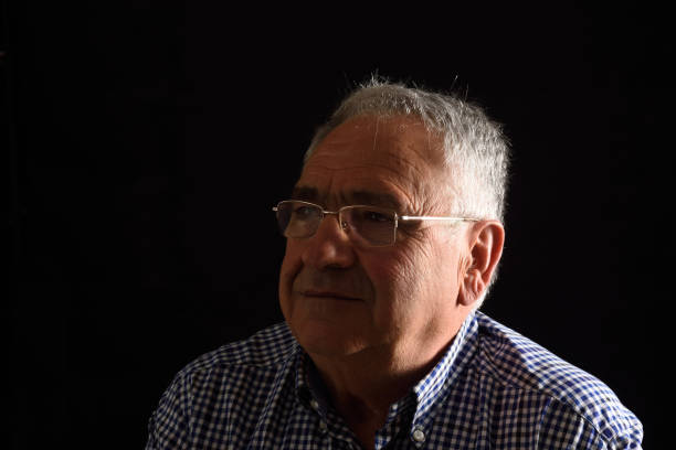 istock Portrait of a senior man with black background 687450012