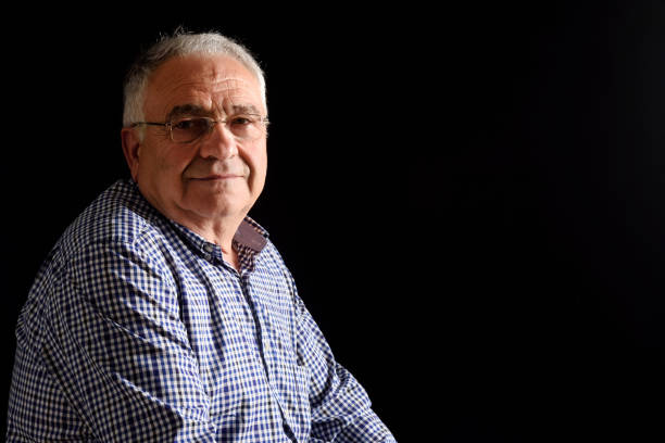istock Portrait of a senior man with black background 687450126