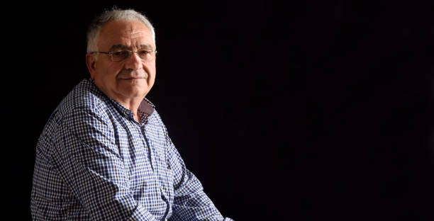 istock Portrait of a senior man with black background 687450148