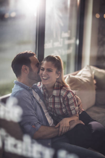 istock Young happy couple flirting while spending time in a cafe. 687454134