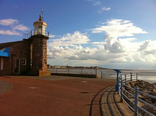Morecambe Pier Lighthouse End of the stone jetty of Morecambe in Lancashire, England with a former lighthouse, now hosting a cafe morecombe bay photos stock pictures, royalty-free photos & images
