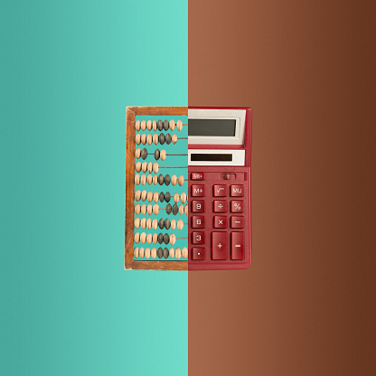 The collage with old wooden abacus and new calculator on colored background. The concept of bookkeeping, business or saving money and old and new technologies