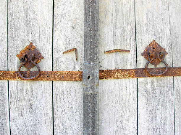 istock old ancient wooden door with rusted knockers or handles 687468066