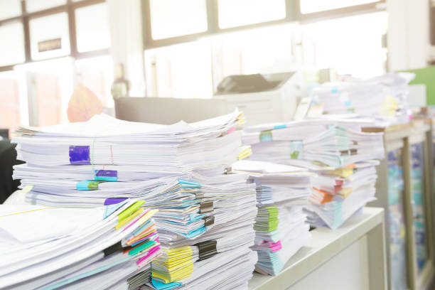 istock Pile of unfinished documents on office desk. 687468180