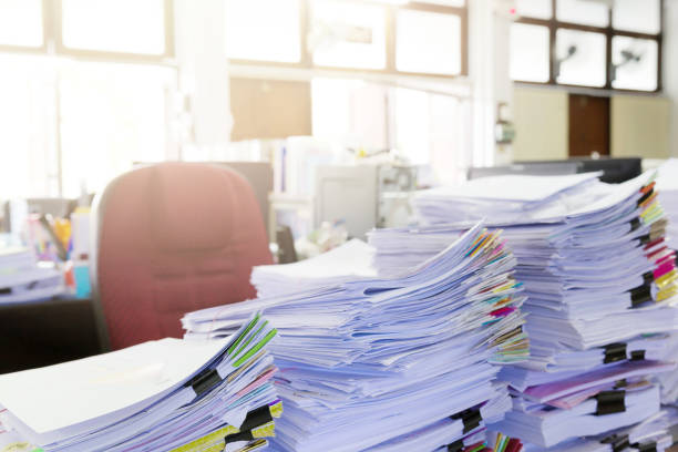 istock Pile of unfinished documents on office desk. 687468534
