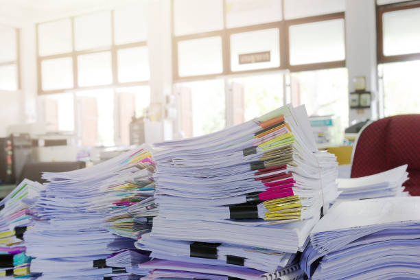 istock Pile of unfinished documents on office desk. 687468656