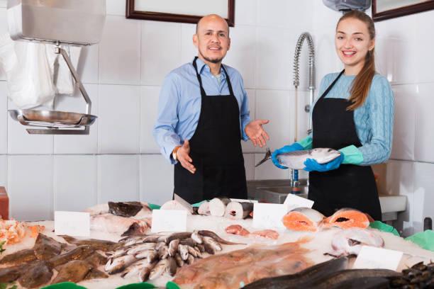 istock Ordinary fish and seafood store with two  sellers indoors 687471644