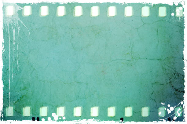istock Vintage blue film strip frame on old and damaged paper background. 687471992