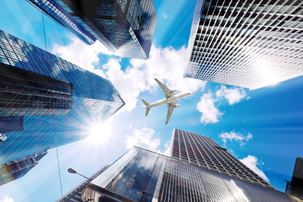istock Airplane flying over business skyscrapers 687472164