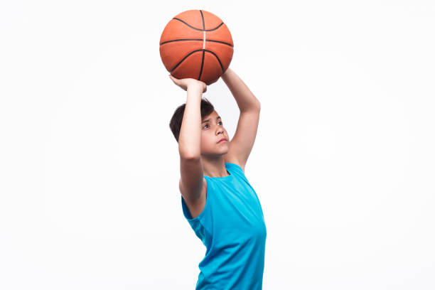 istock Young boy throwing basket ball 687472508