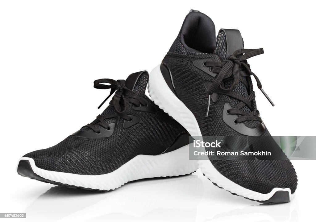 Running shoes, sneakers or trainers isolated on white Pair of new unbranded black sport running shoes or sneakers isolated on white background with clipping path Sports Shoe Stock Photo