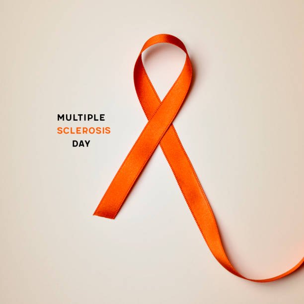 orange ribbon and text multiple sclerosis day the text multiple sclerosis day and an orange ribbon on a beige background sclerosis stock pictures, royalty-free photos & images