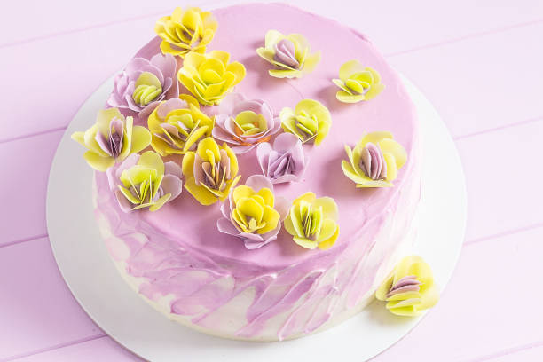 istock Mousse cake with colorful flowers decoration 687483494