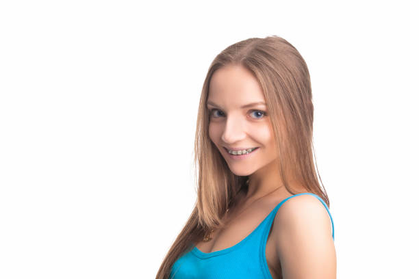 Pretty Blond Girl With Brackets on Her Teeth. Isolated Over White Background. Horizontal Image