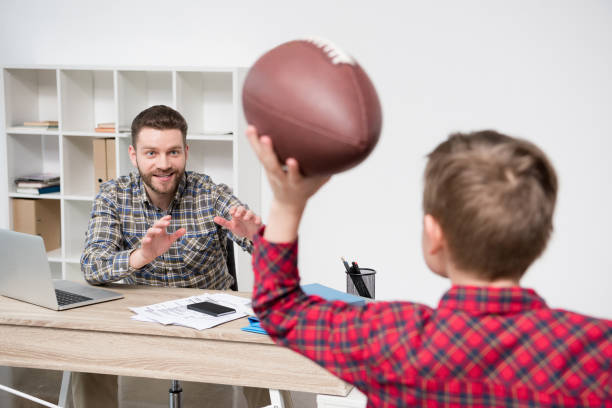 istock Businessman freelancer with his son wit ball at home office 687483558